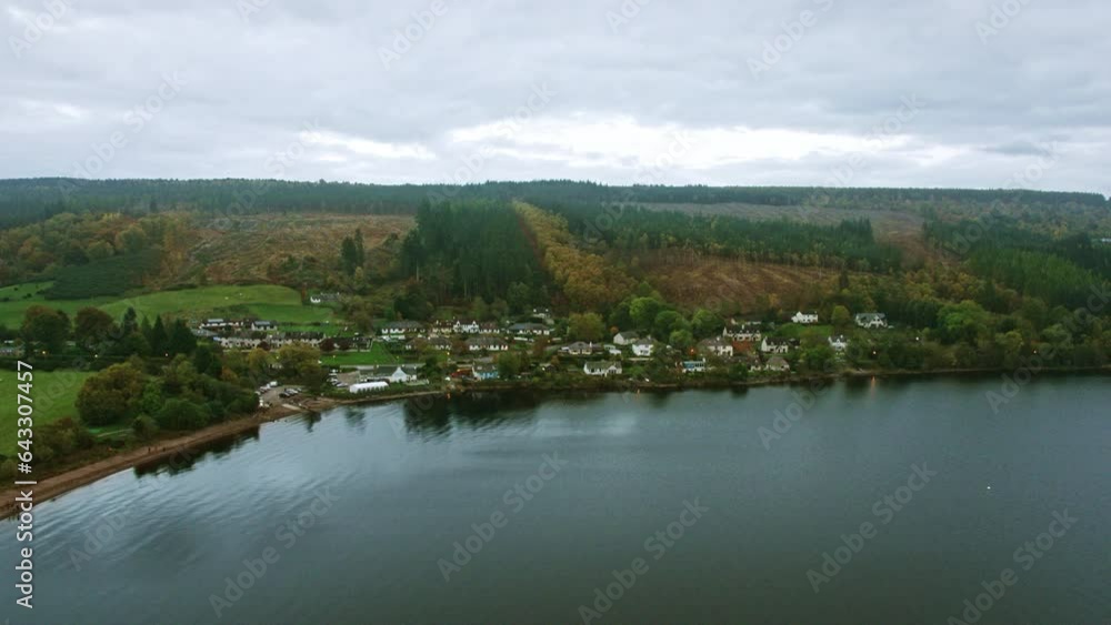 Drone flying in on small Scotland village near lake Drone flying in on small Scotland village near lake
