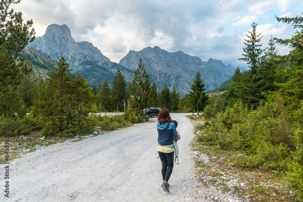 A young woman with her son walking on a trail in the Valbona valley, Theth national park, Albanian Alps, Valbona Albania