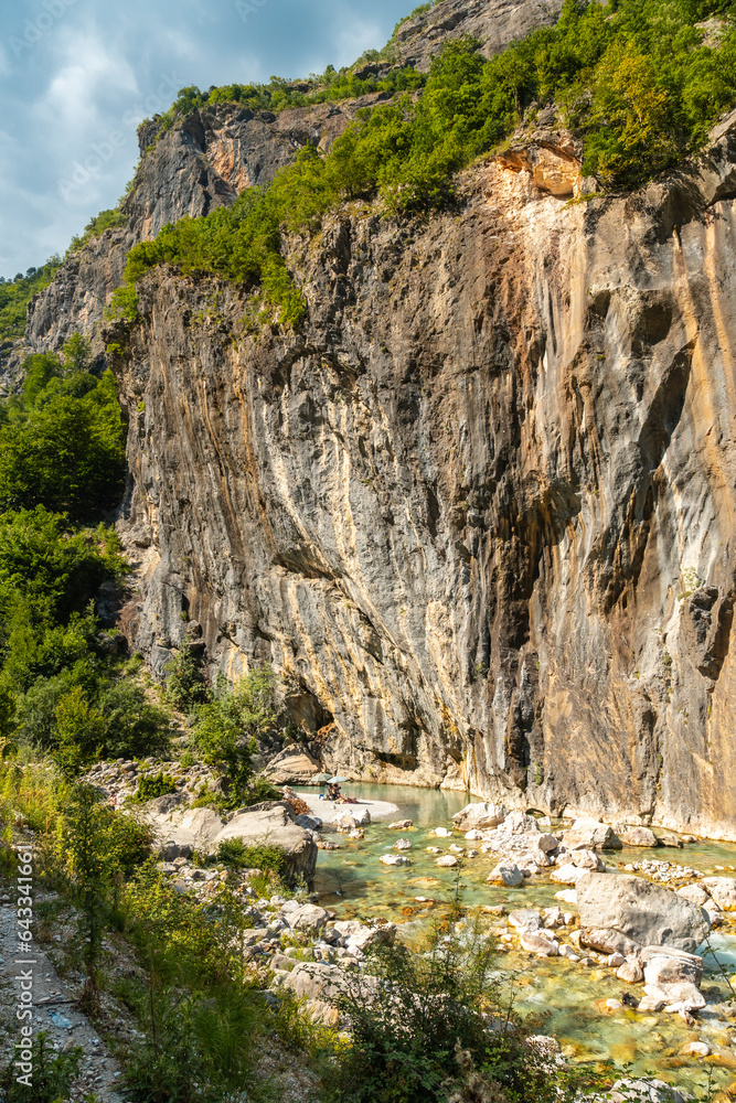 Obraz premium Bathing beach in the beautiful turquoise river of Valbona Valley, Theth National Park, Albanian Alps, Albania