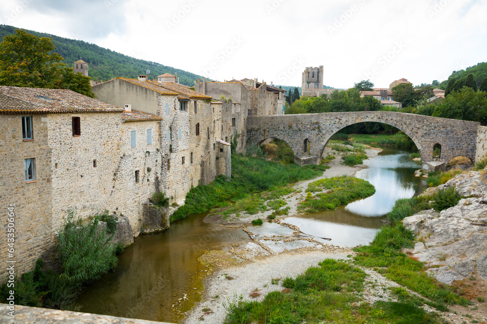 View of medieval stone arched bridge of Benedictine Abbey Sainte-Marie d'Orbieu in Lagrasse
