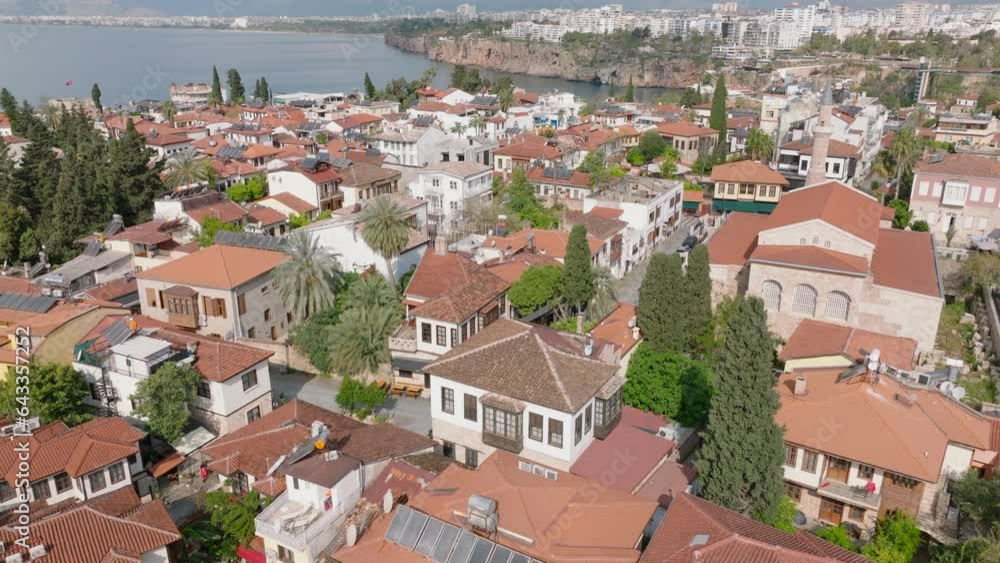 Aerial view of houses with tiled roofs. Sehzade Korkut Mosque with minaret. housing estate at sea coast in background. Antalya, Turkey Aerial view of houses with tiled roofs. Sehzade Korkut Mosque with minaret. housing estate at sea coast in background. Antalya, Turkey