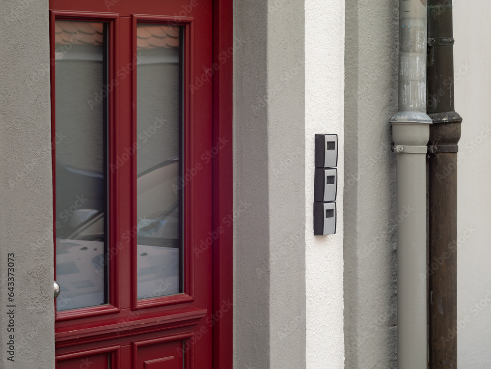 Obraz premium Key boxes next to a building entrance door. The keys are locked for tourists who booked an apartment to make holiday. Self service to open the door without the host.