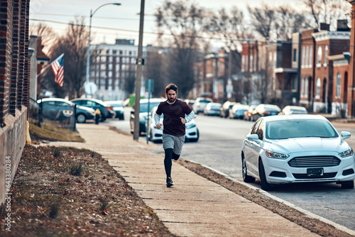 Young man running on a sidewalk in the suburb © Geber86