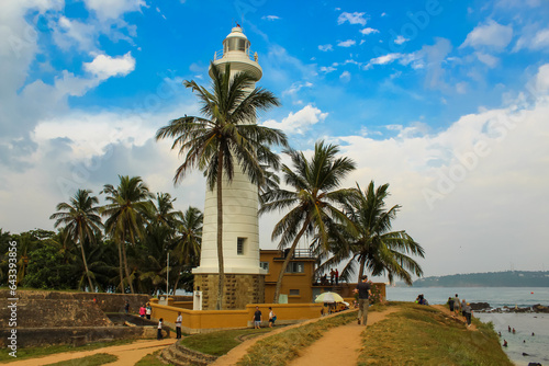 Lighthouse in Galle fort, Sri Lanka. Indian ocean shore, palms, Sri Lanka. photo