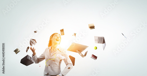 Photos Young pretty businesswoman juggling with business items