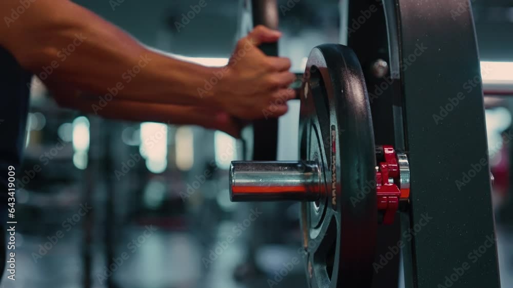 Barbell Weights Equipment, Gym Barbell. Man Setting Up Barbell with Additional Weights at Fitness Center Barbell Weights Equipment, Gym Barbell. Man Setting Up Barbell with Additional Weights at Fitness Center