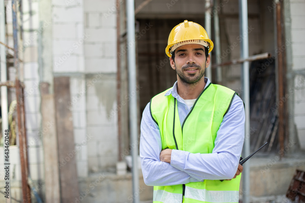 Construction engineer. happy man engineer wear uniform standing at construction site. Workers supervise construction inspection of building. Construction engineer. happy man engineer wear uniform standing at construction site. Workers supervise construction inspection of building.