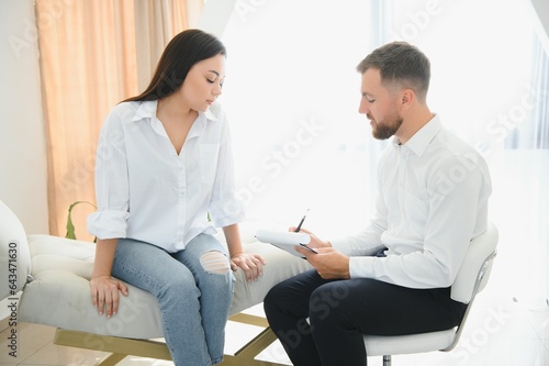 Young woman visiting therapist counselor. Girl feeling depressed, unhappy and hopeless, needs assistance. Serious disease, unwilling pregnancy, abort or death of loved one, addiction to drugs concept