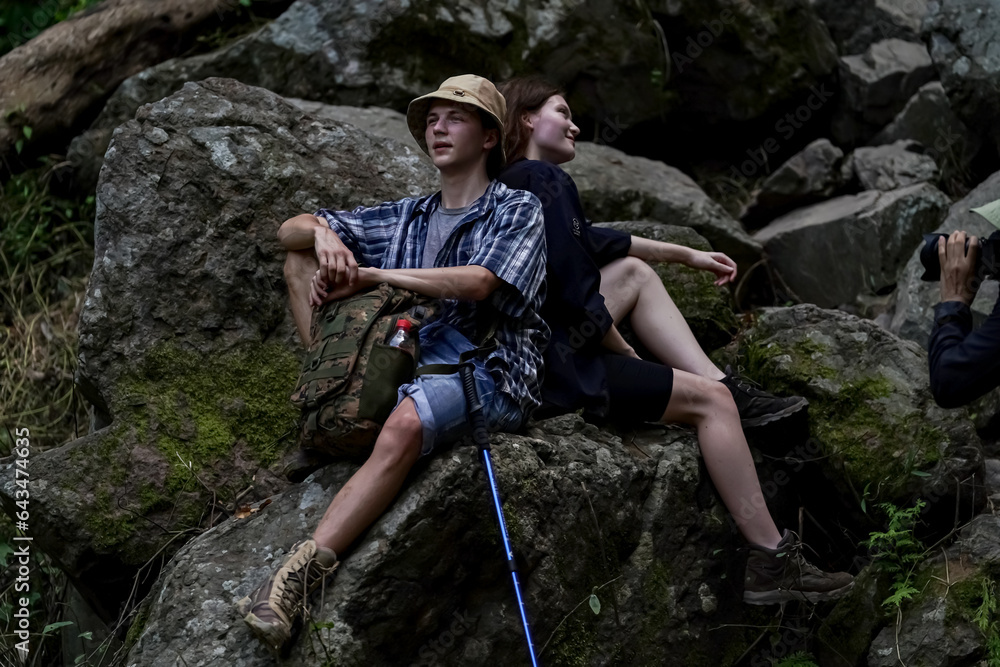 Smiling young people enjoying hiking at nature and talking outdoor. young people Hiking On Mountain And Enjoys Nature. Smiling young people enjoying hiking at nature and talking outdoor. young people Hiking On Mountain And Enjoys Nature.