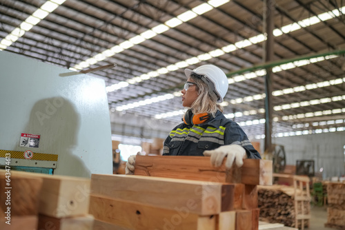 Worker are working at lumber yard in Large Warehouse. Worker are working.on woodworking machine, lumber and Inventory check at Storage shelves in lumberyard.