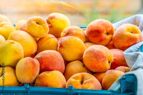 Harvest ripe peaches in a box close-up
