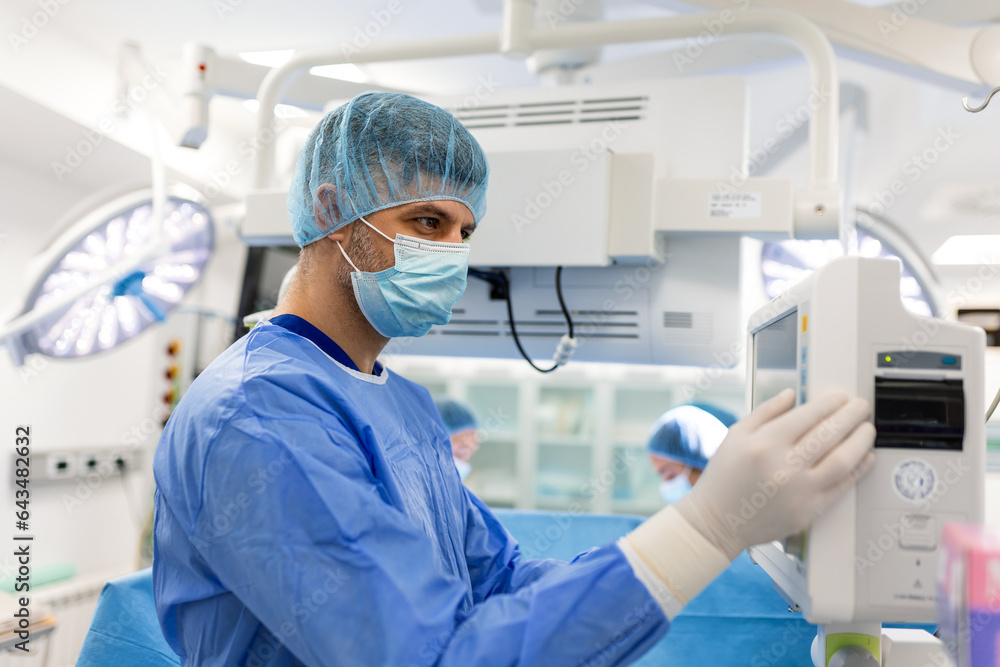 Medical ventilator being monitored by anaesthetist. surgeon using ...