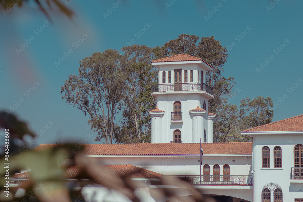 Detail of a tower of museum of costarican art in the capital of san jose on a sunny spotless cloud. White tower is seen rising up.