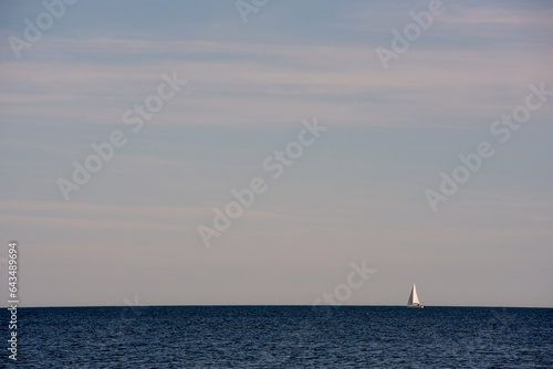 A sailboat heading out to sea on a beautiful summer day © Jarkko