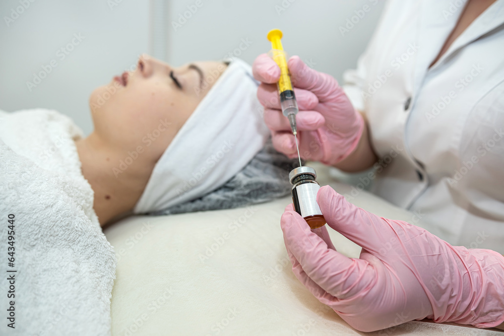 Young female client receiving cosmetology treatment botox injection at spa clinic Young female client receiving cosmetology treatment botox injection at spa clinic
