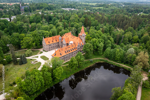 Cesvaine medieval castle in Latvia from above. Building of stones with a brown tiled roof.