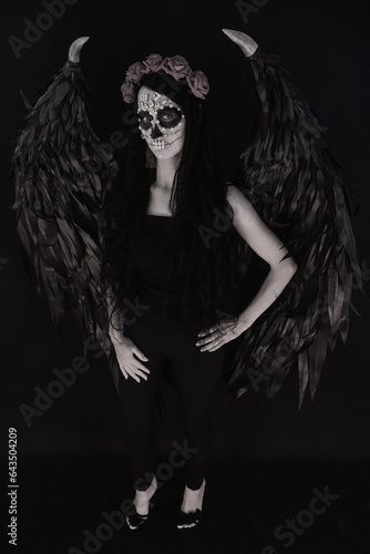 woman look as angel Death with red  roses wreath full length sho