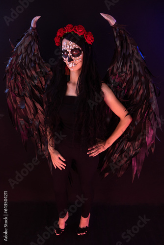 woman look as angel Death with red  roses wreath full length sho