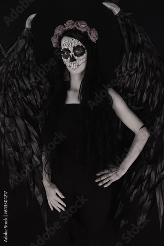 woman look as angel Death with red  roses wreath
