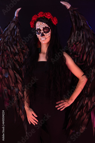 woman look as angel Death with red  roses wreath