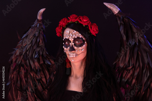 woman look as angel Death with red  roses wreath  closeup