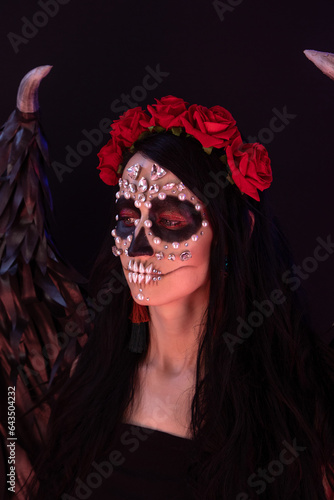 woman look as angel Death with red  roses wreath  closeup