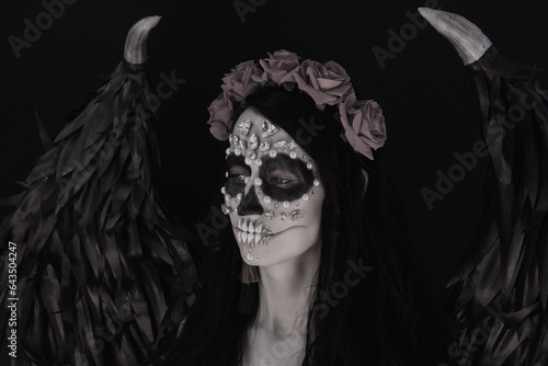 woman look as angel Death with red  roses wreath  closeup