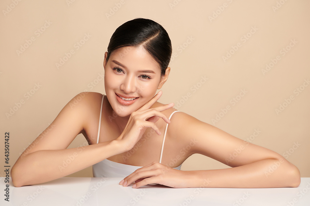 Fototapeta premium Beautiful young asian woman with clean fresh skin on beige background, Face care, Facial treatment, Cosmetology, beauty and spa, Asian women portrait.