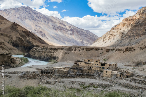 Trekking past an abandoned village along the Tsarab Chu River in Zanskar, Ladakh, India