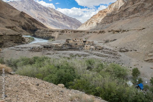 Trekking past an abandoned village along the Tsarab Chu River in Zanskar, Ladakh, India