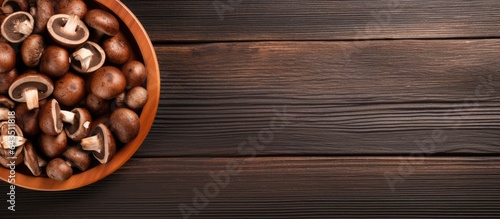 Shiitake mushrooms on a brown plate top view rustic wooden background
