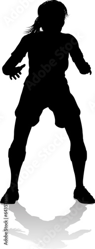 A female soccer football player woman in silhouettes