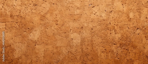 Close up of a textured cork board with a wooden background and space for notes or planning