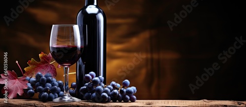 Red wine bottle and glass old snag backdrop blue grapes Space to copy