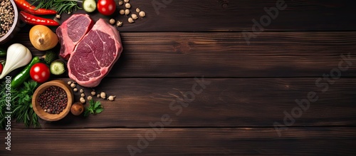 Vegetables and beef steaks on a wooden backdrop