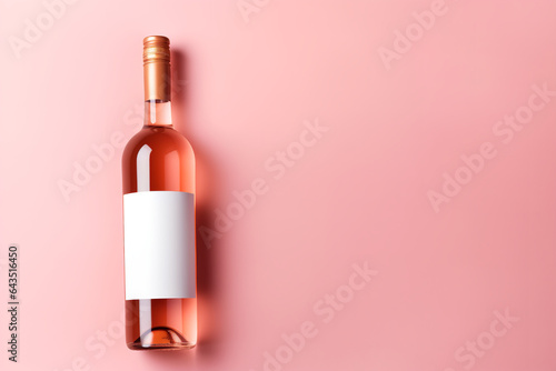Wine bottle mockup, unopened bottle of rose wine on pink background, top view, copy space, flat lay
