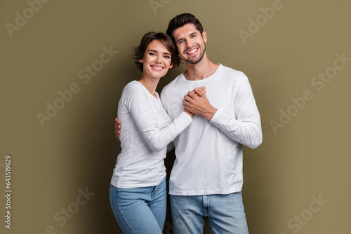 Photo of positive sweet hugging couple wear white clothes enjoy time together anniversary honeymoon isolated on brown color background