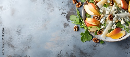 Top view of gray stone background with French autumn salad featuring pears walnuts and blue cheese Copy space available