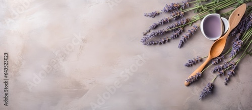 Wooden kitchen cutlery and lavender flowers on a plaster background perfect for showcasing your product or copy photo