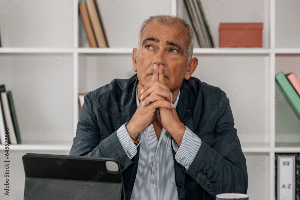 thoughtful middle aged business man in office thoughtful middle aged business man in office