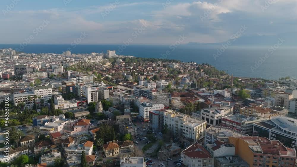 Forwards fly high above city at golden hour. Buildings in summer vacation tourist destination at seaside. Antalya, Turkey Forwards fly high above city at golden hour. Buildings in summer vacation tourist destination at seaside. Antalya, Turkey