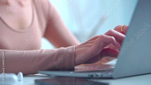 Close up hand  Asian young non binary man using laptop at home. photo