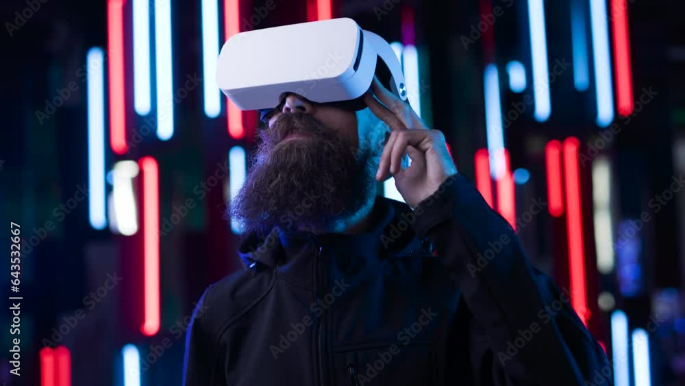 Brutal man in futuristic costume. Guy in glasses of virtual reality ...