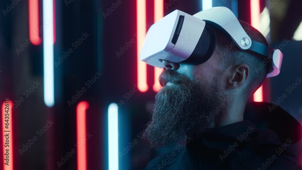 Brutal man in futuristic costume. Guy in glasses of virtual reality ...