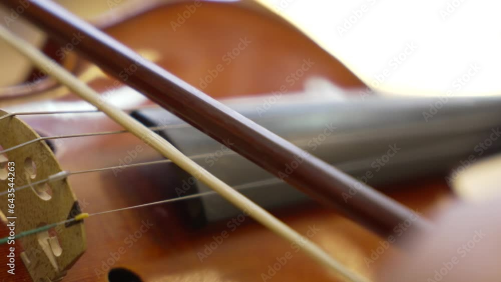 Detailed Close-Up of a Violin Strings and Bow in Motion. Detailed Close-Up of a Violin Strings and Bow in Motion.