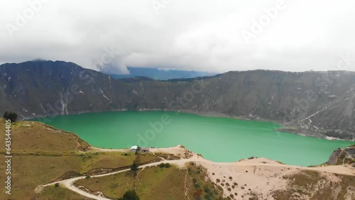 Aerial Pull Out Wide Shot with Scenic Views Overlooking the Turquoise Quilotoa Lake in Ecuador.