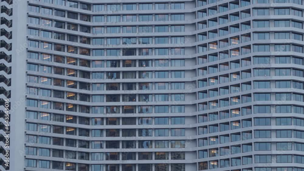A timelapse of a modern building's transition from dusk to night in the city. A timelapse of a modern building's transition from dusk to night in the city.