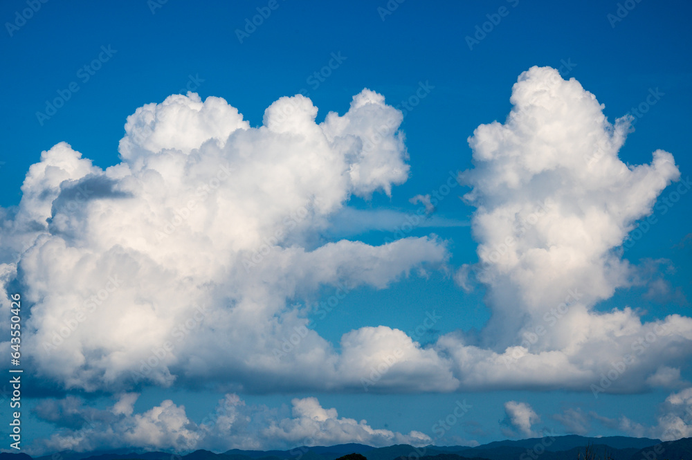 Nature's Canvas: Dynamic White Clouds Drifting Across the Mountain's Blue Sky. View of the urban landscape from Dajianshan Mountain, New Taipei City, Taiwan. Nature's Canvas: Dynamic White Clouds Drifting Across the Mountain's Blue Sky. View of the urban landscape from Dajianshan Mountain, New Taipei City, Taiwan.