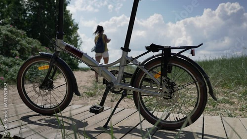 Bicycle by the sea on a sunny day among the sand. The girl left the bike on the shore and went to the sea. Seascape.