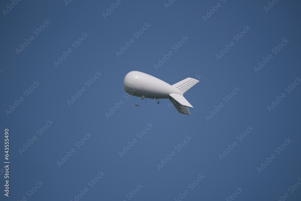 AIRSHIP - Flying object against the blue sky AIRSHIP - Flying object against the blue sky